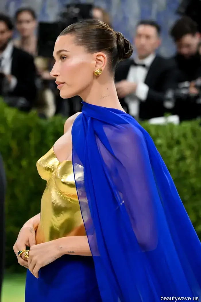 Hailey Bieber’s Goddess Bun is just as deliberate as her 24K gold breastplate.