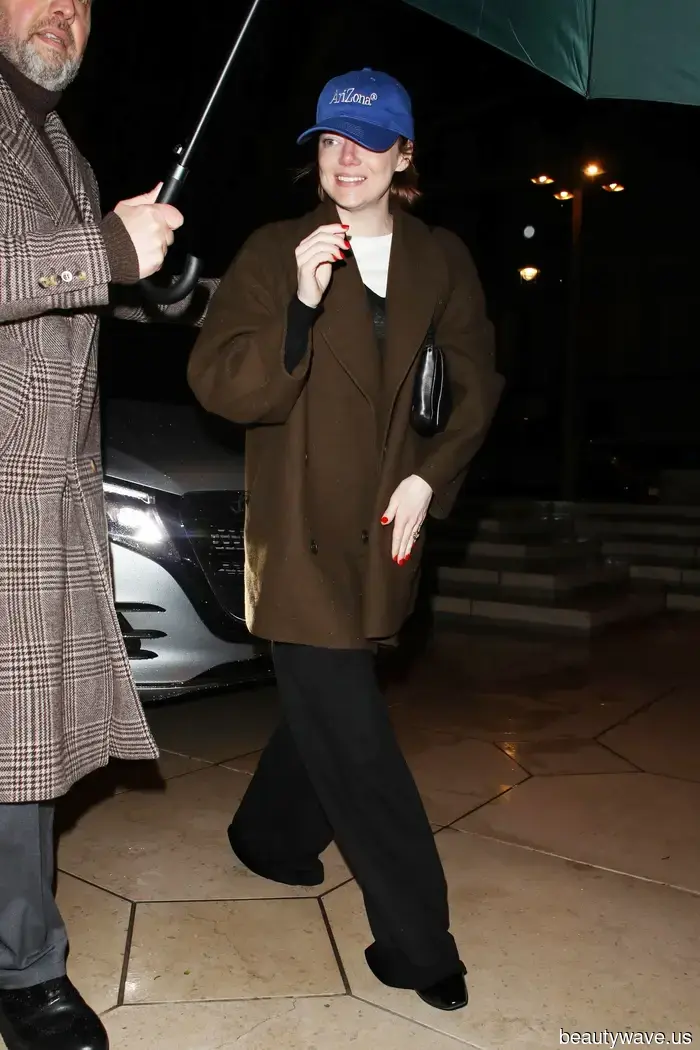 Emma Stone Discovered the Most Stylish Way to Sport a Brown Coat, Right down to Her Red Nails.