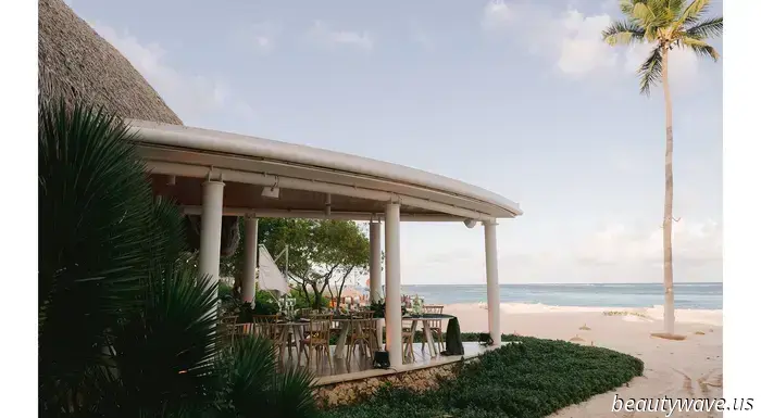 The bride donned a custom-made dress, while the groom opted for Ralph Lauren for their stunning beach wedding in the Caribbean.